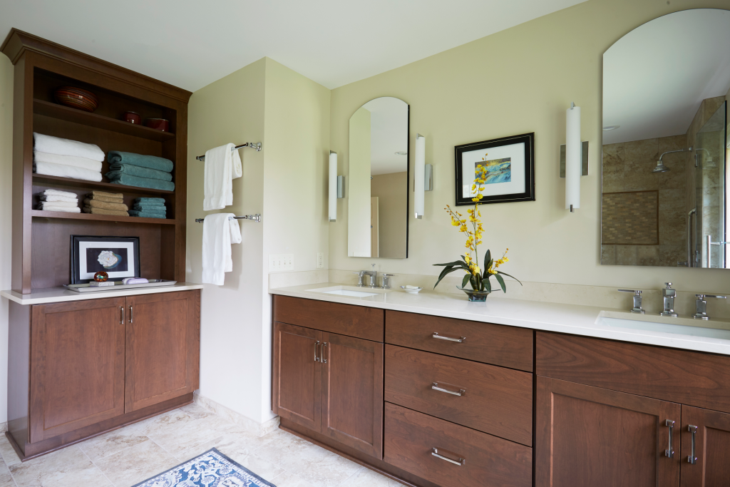 Bathroom shown with scone lighting