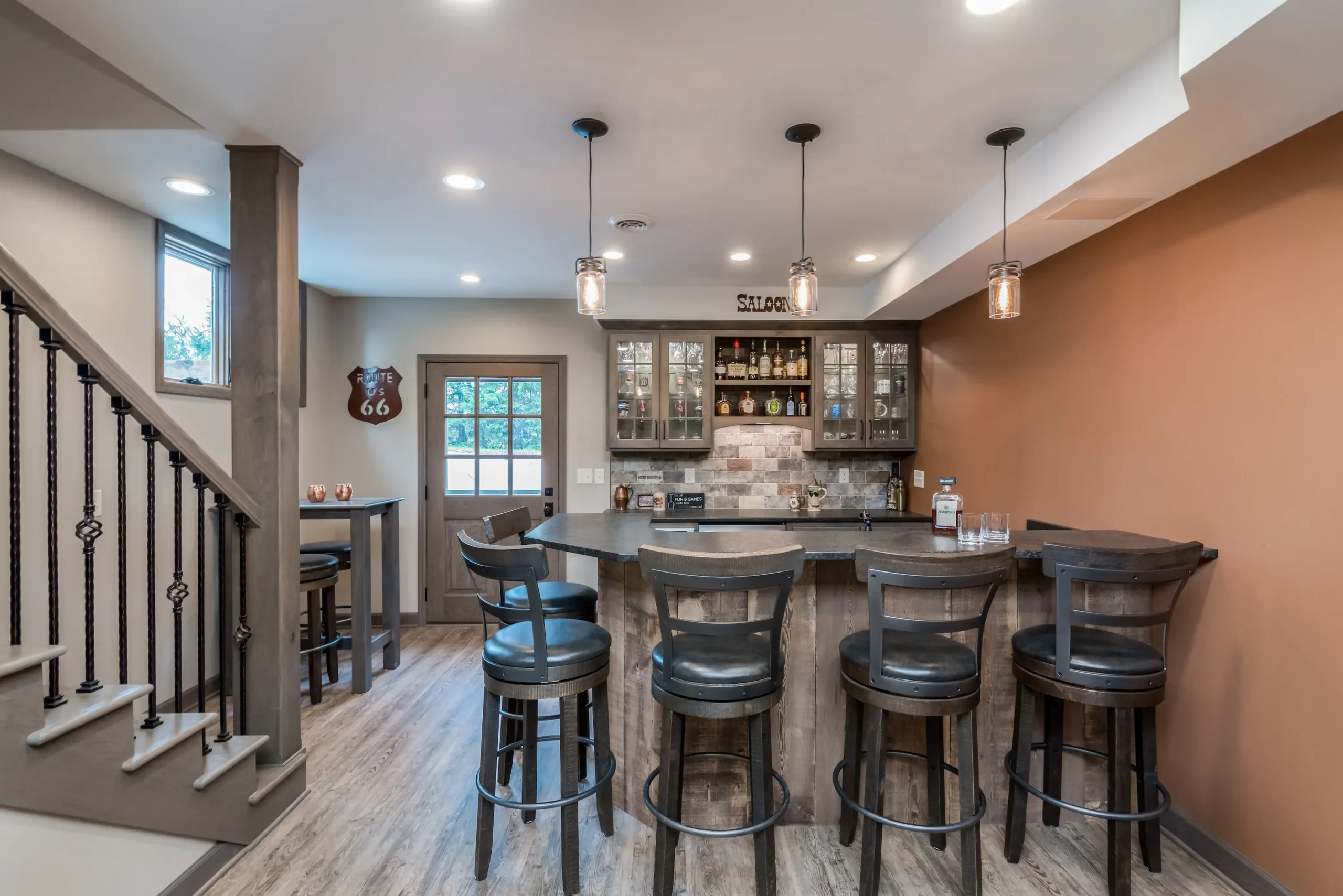 Lower-level bar and seating area arranged for entertaining