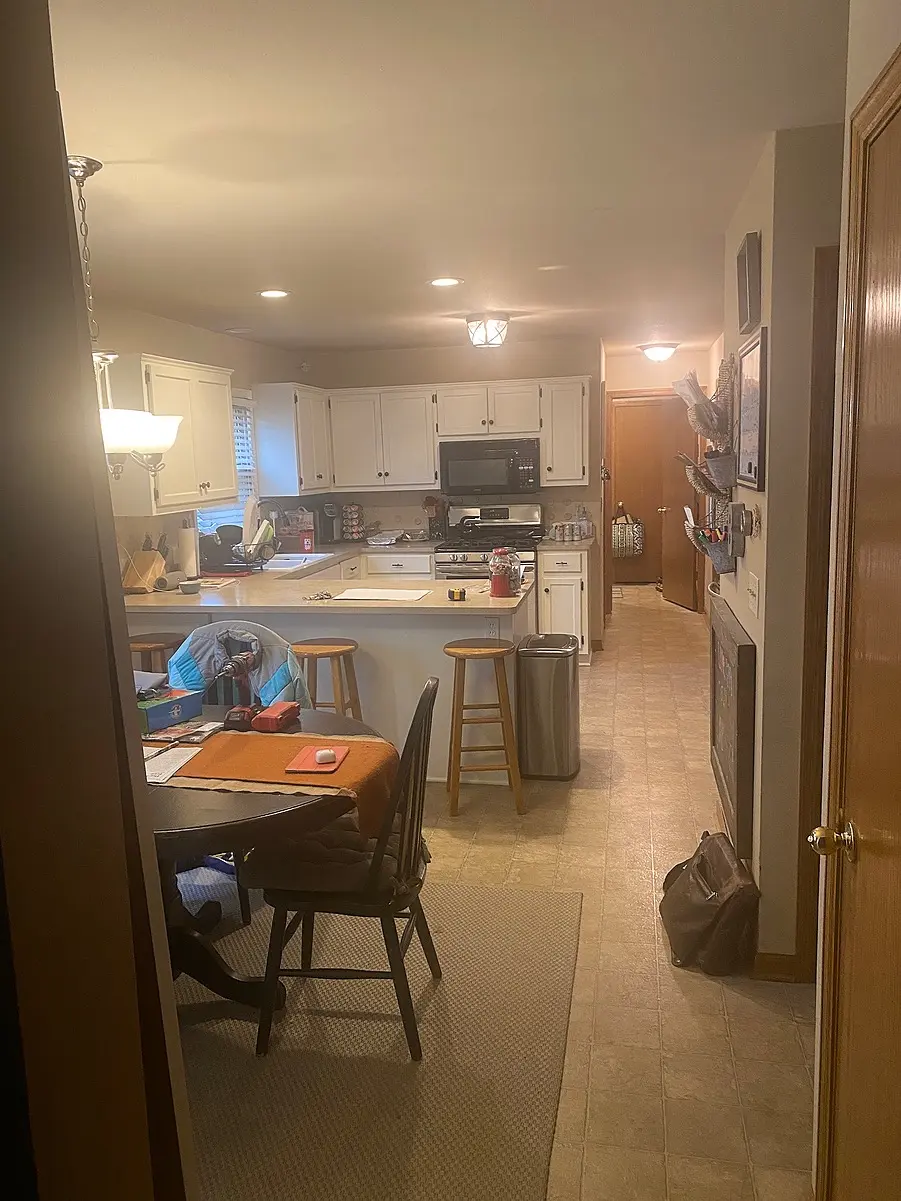 Oak Creek kitchen before remodeling with a peninsula and dining table sharing the central walkway