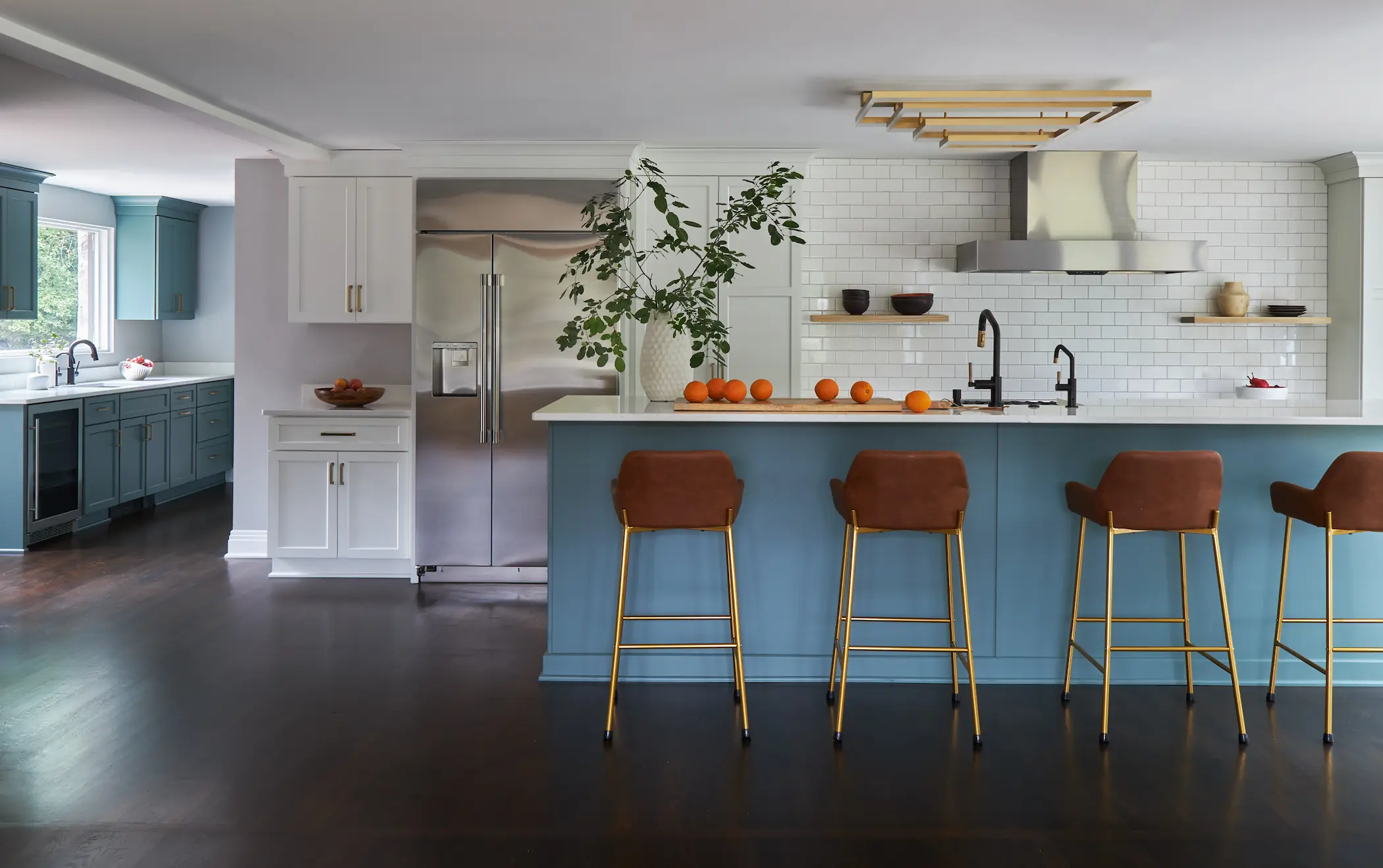Completed Mequon kitchen with connected work zones, island seating, and a separate beverage area