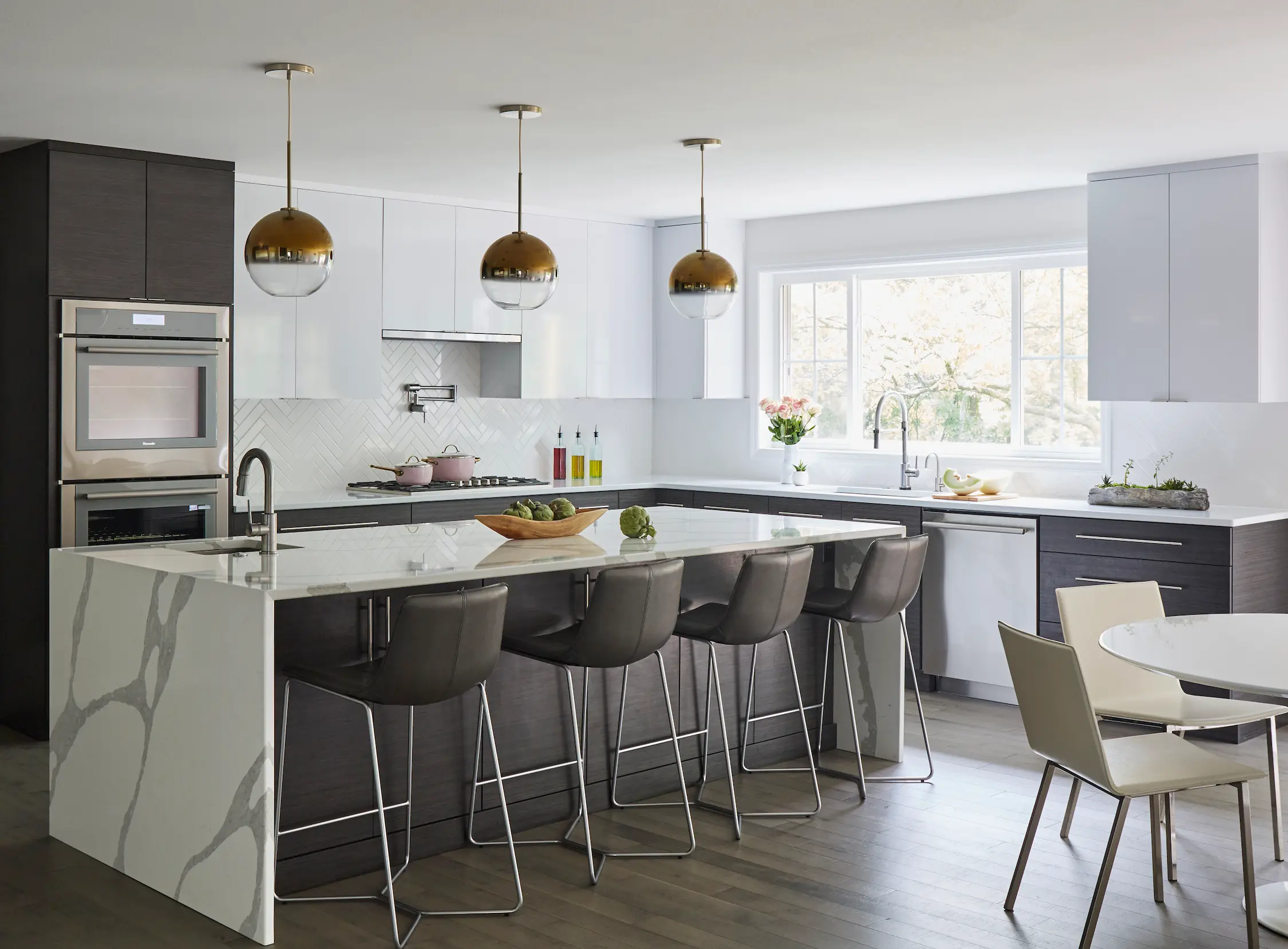 Contemporary Mequon kitchen with a large island, connected work areas, and seating